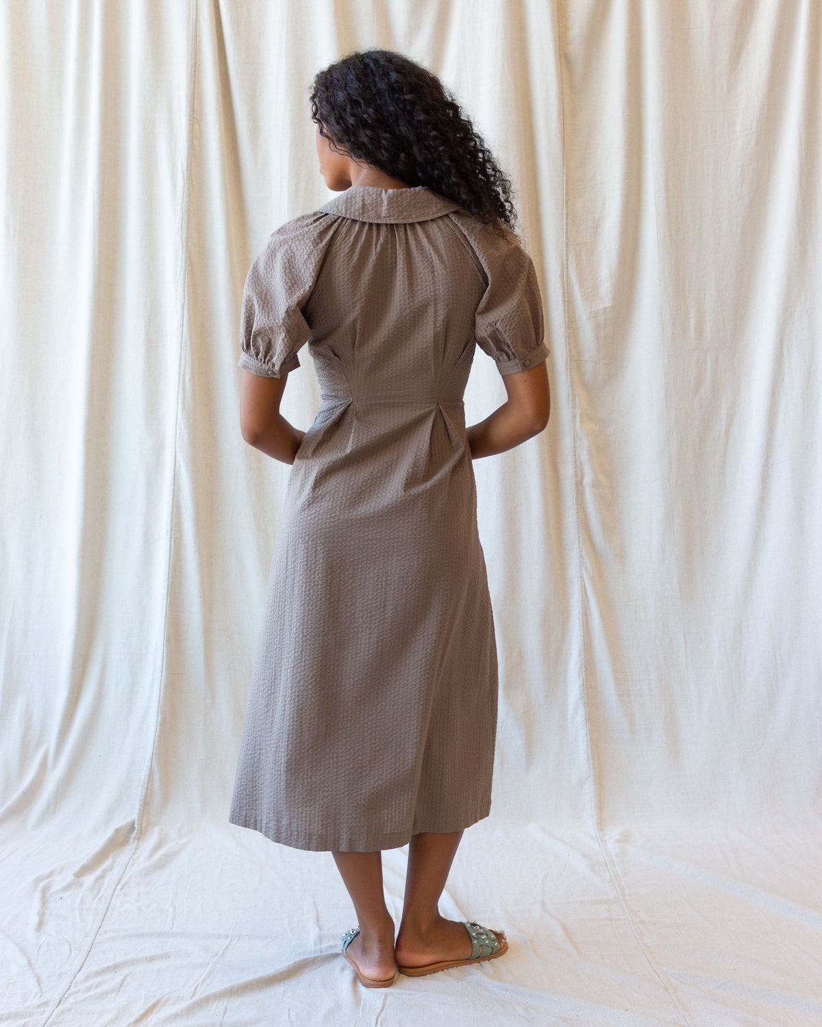Women's field dress in pine bark, back view midi with puff sleeves and high yoke seam