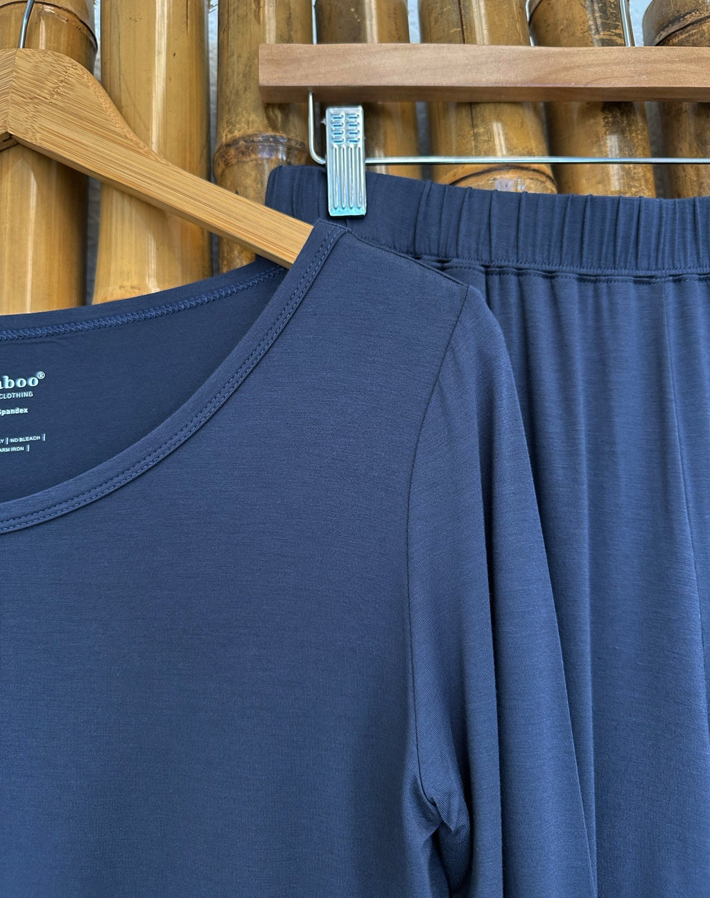 Navy long-sleeve lounge T-shirt detail with scoop neck on hanger