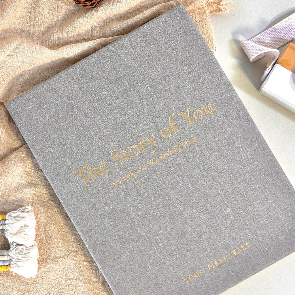 Gray book cover with gold “The Story of You” title and “Four First Years”