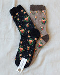 Pair of crew socks with fall floral print, dark and tan colorways
