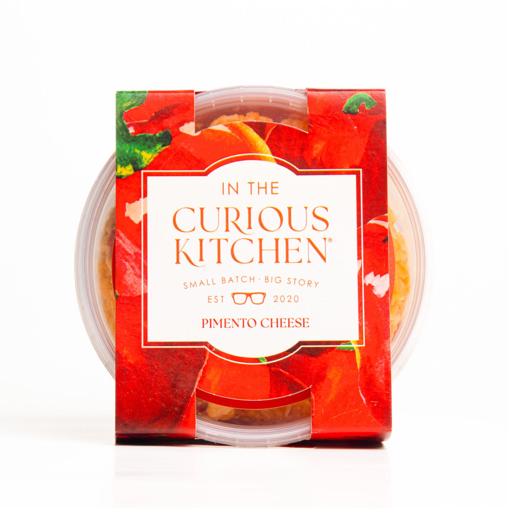 Pimento cheese spread in clear plastic tub with red label and snap lid