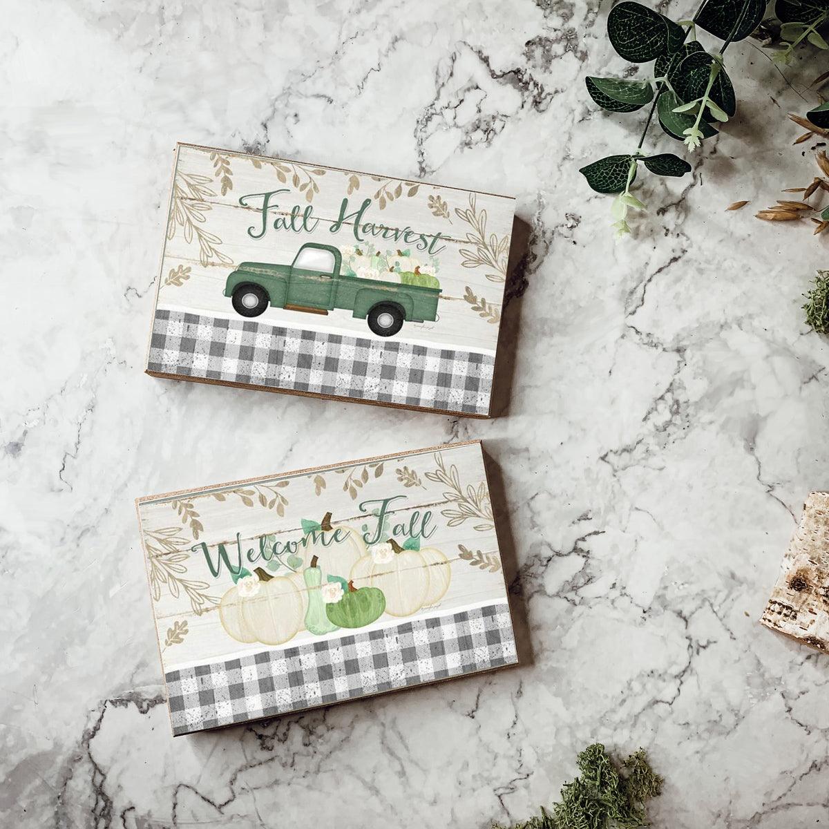 Two fall greeting cards on marble with welcome pumpkins and green truck design