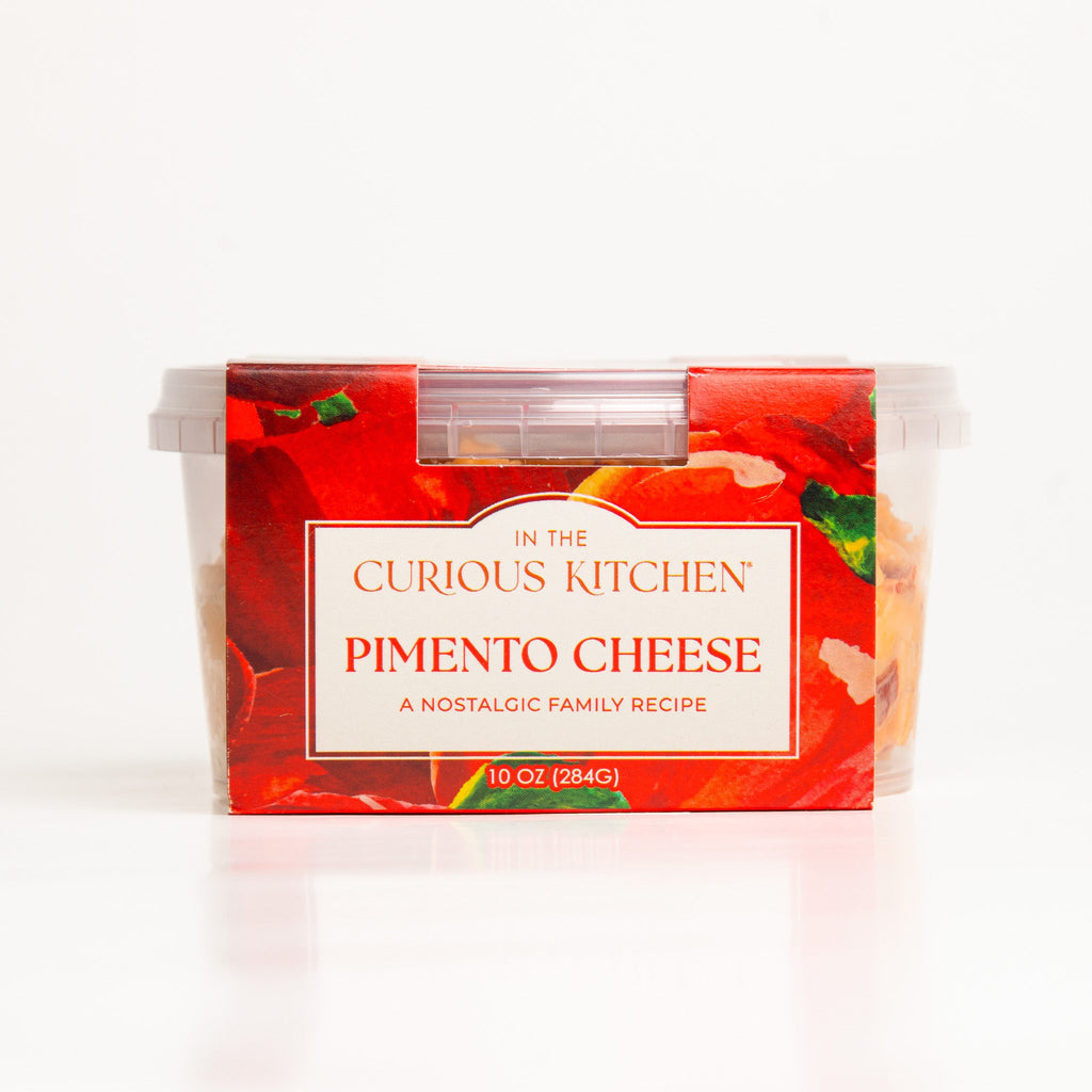 Pimento cheese spread tub with red front label and clear lid