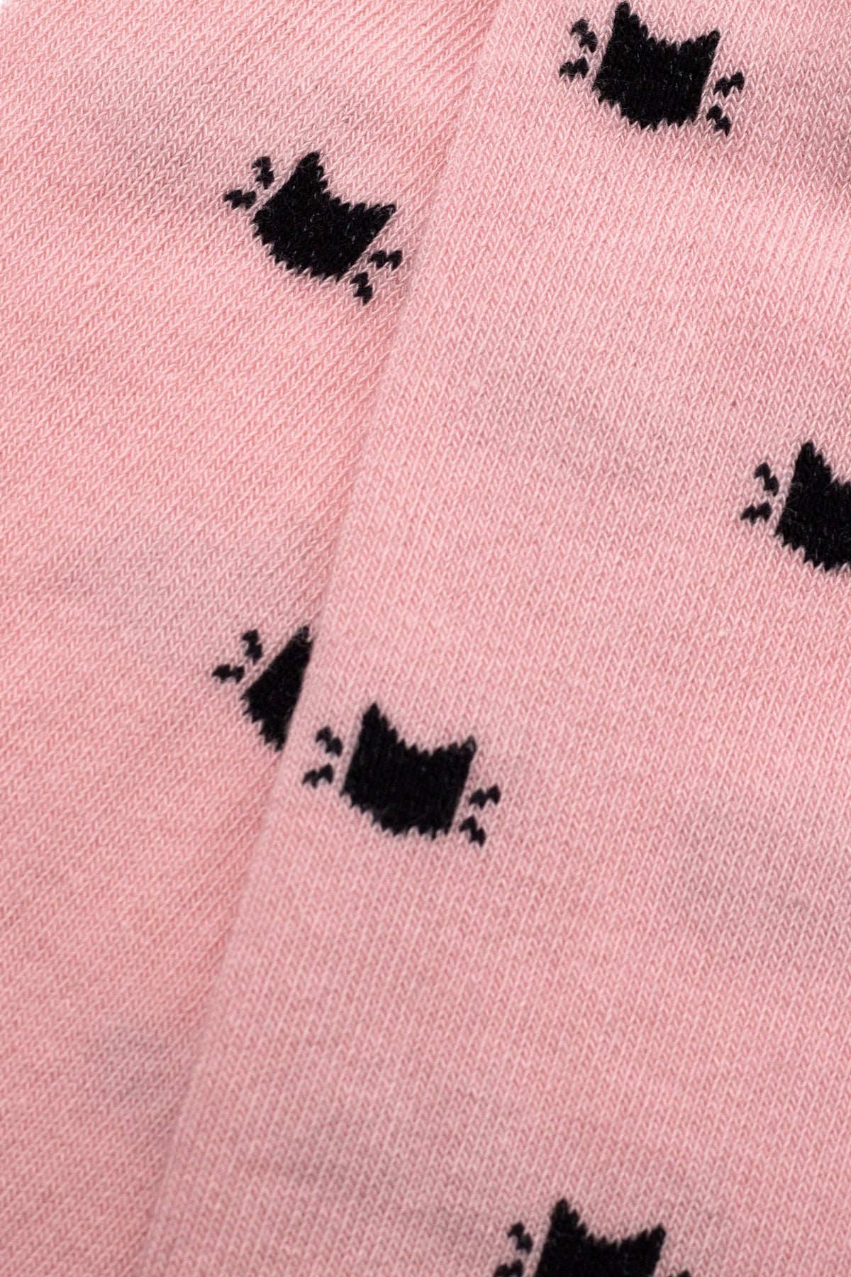 Light pink kids cotton tights close-up showing repeating black cat silhouettes