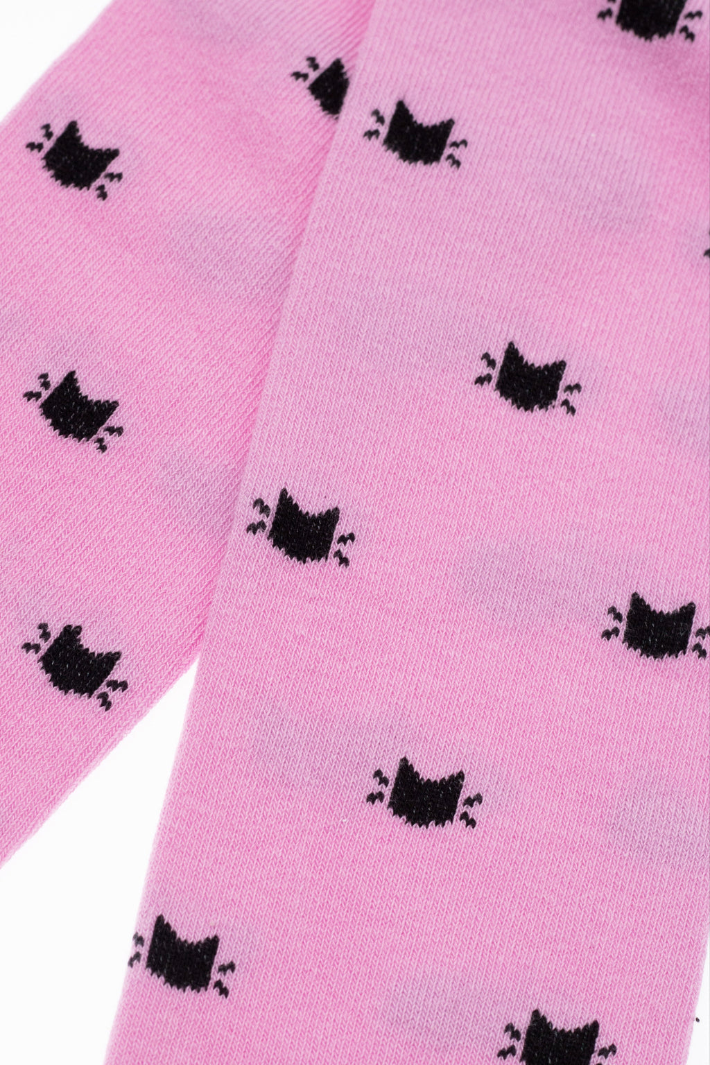 Light pink kids cotton tights close-up with fine knit texture and black cat silhouettes