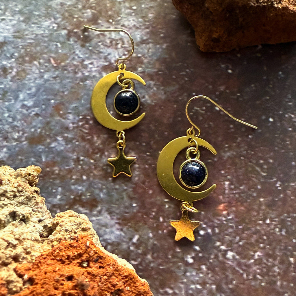 Gold crescent moon earrings with dark blue stones and dangling star charms