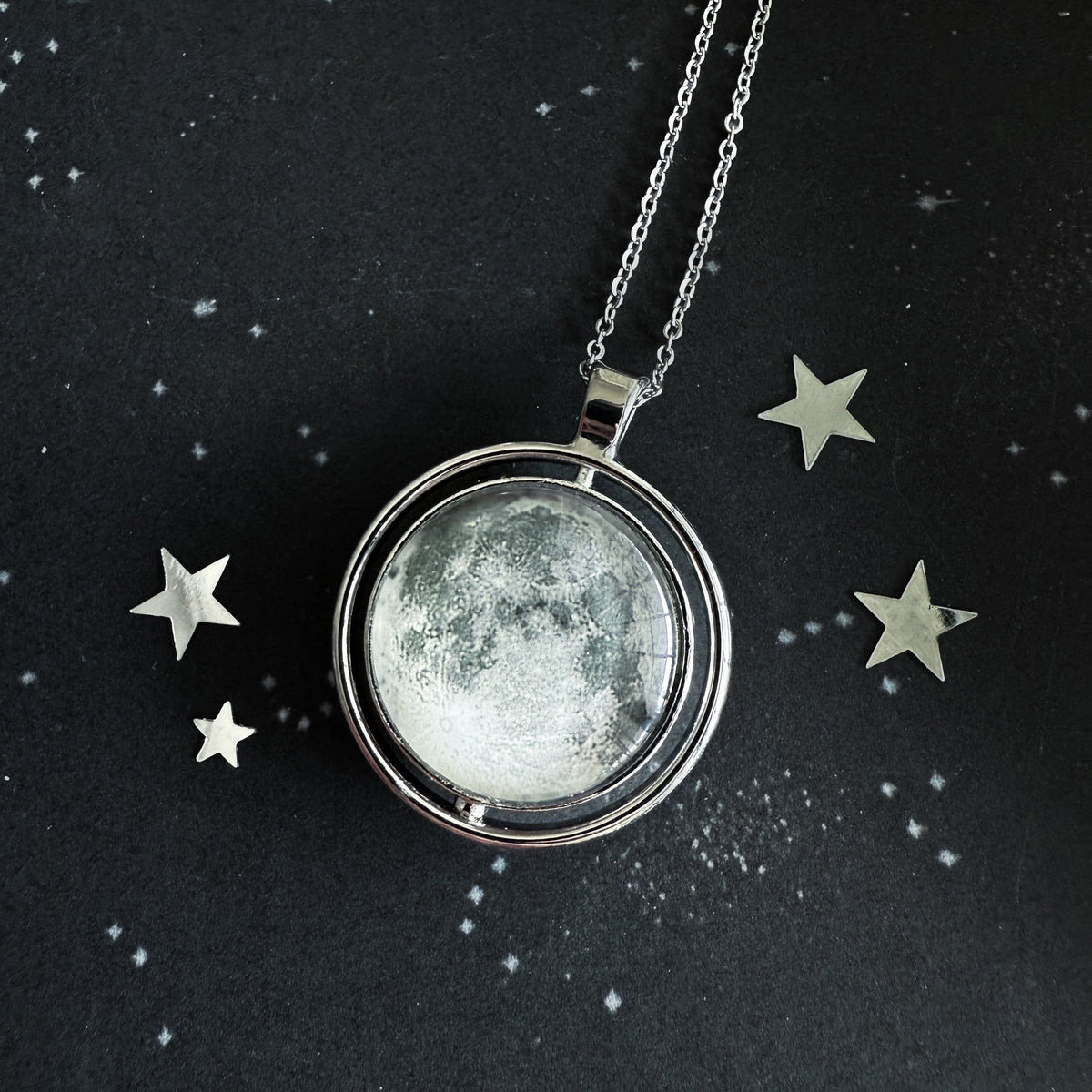Round moon fidget pendant necklace with textured silver-toned pendant and chain