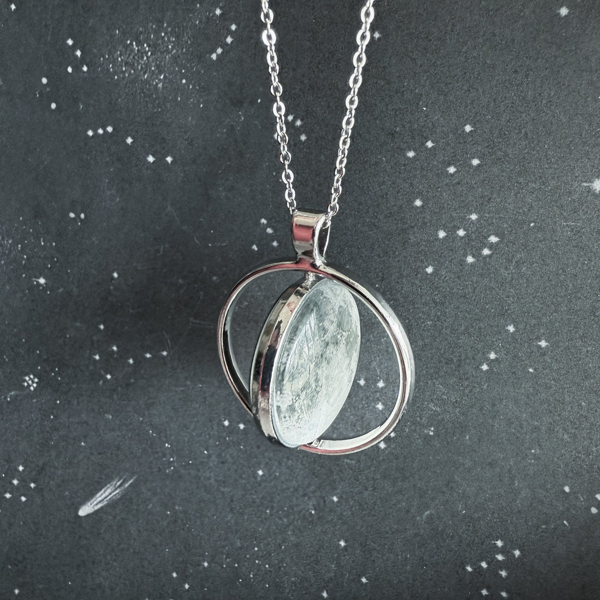Double-sided round moon fidget pendant necklace, side view of the open back
