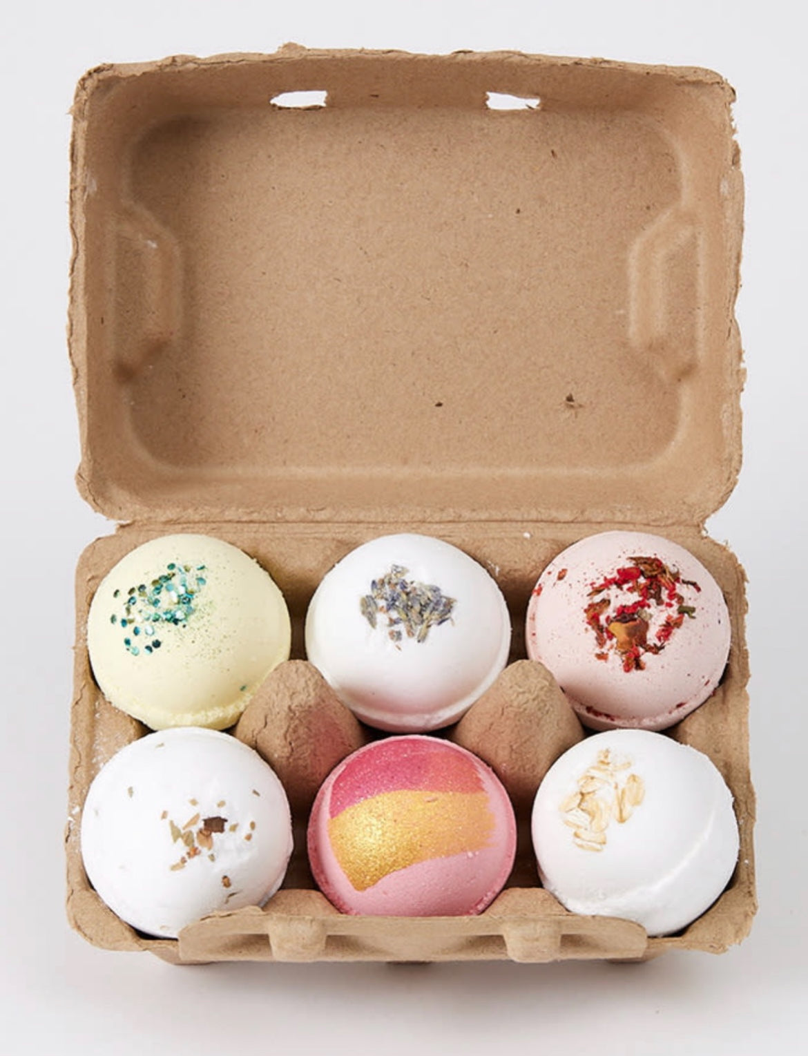 Mini bath bomb bundle in open kraft box with six pastel bath bombs