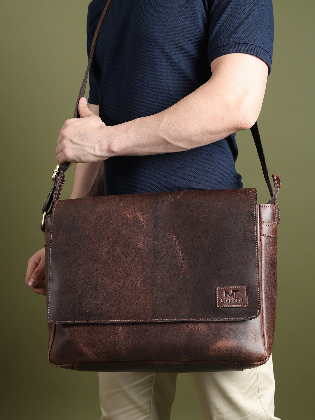 Genuine Sitka leather laptop bag carried on shoulder with front flap, dark brown.