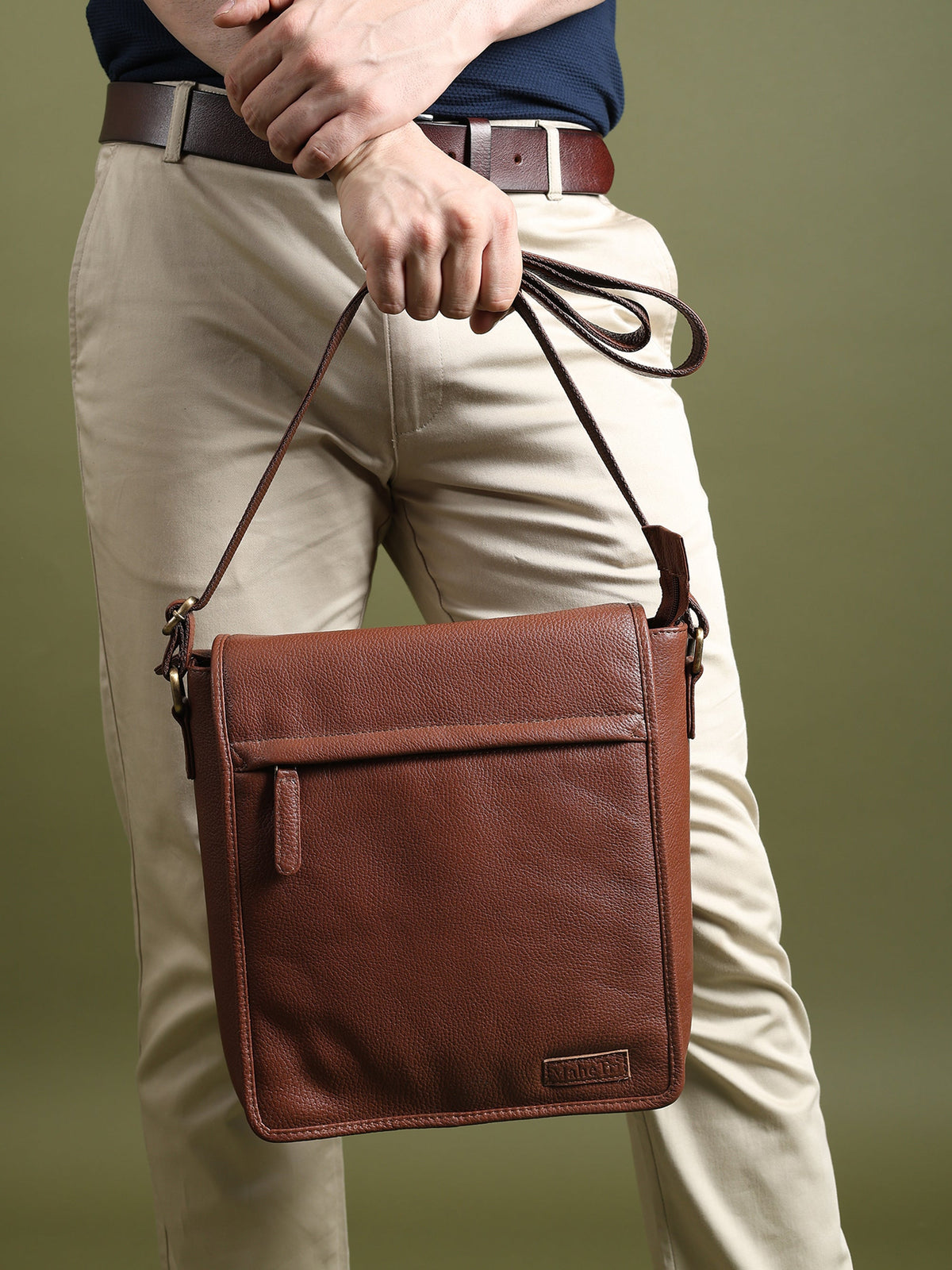Brown leather crossbody bag with front pocket and adjustable shoulder strap