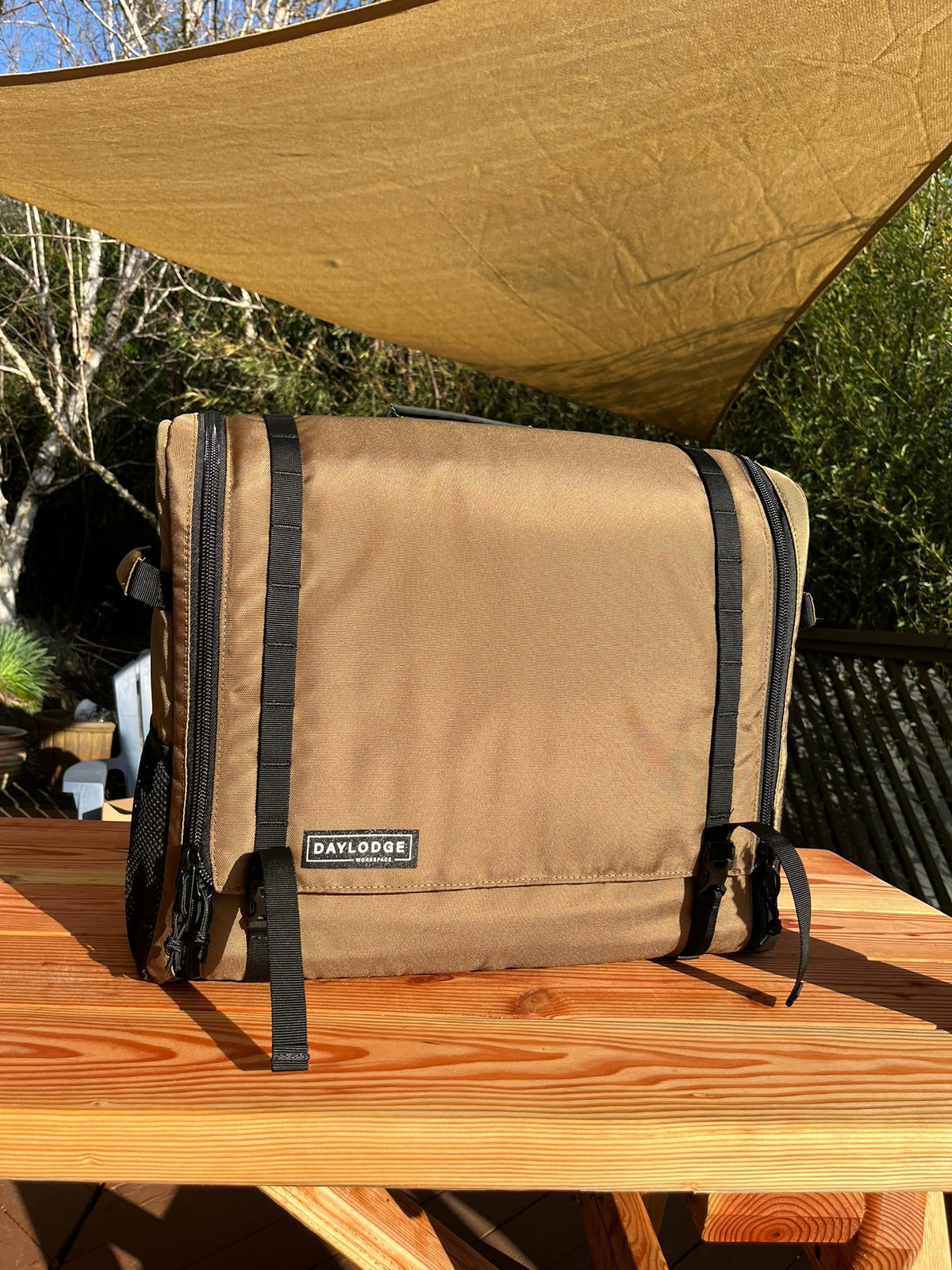 Mobile camp kitchen storage bag, tan canvas with black trim and side straps