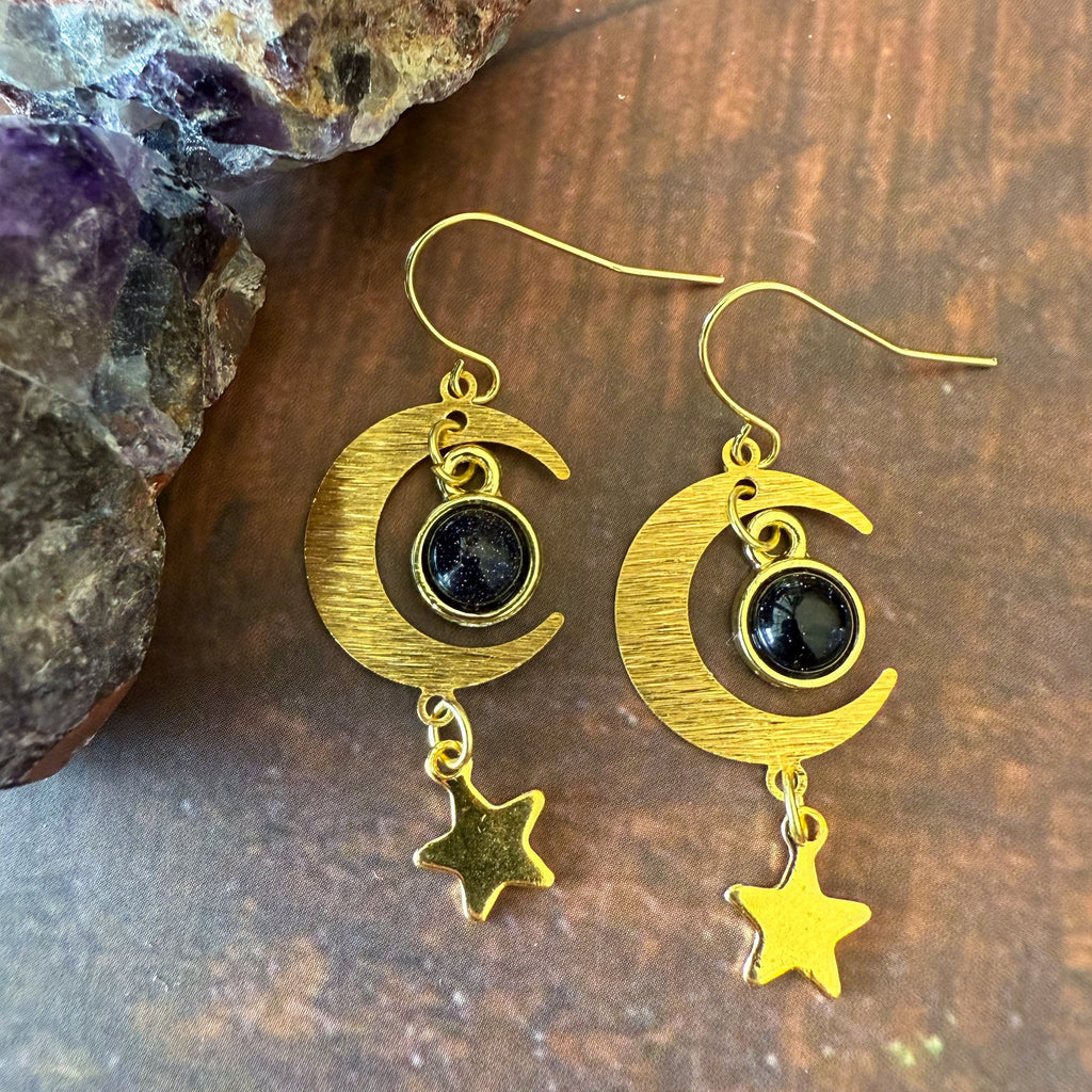 Gold crescent moon earrings with dark blue stones and small star dangle charms