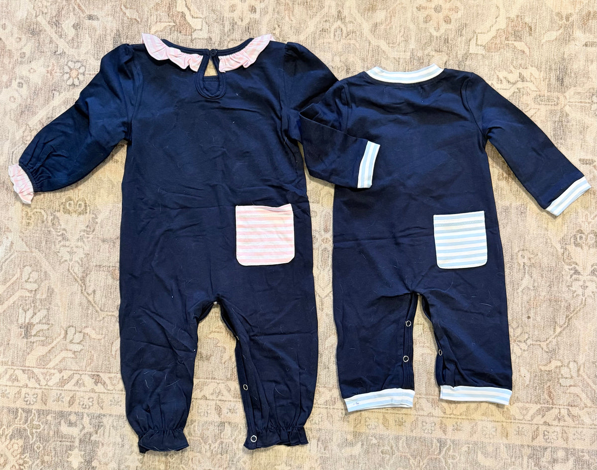 Boys navy romper with ruffle neckline, chest patch detail, and striped cuffs