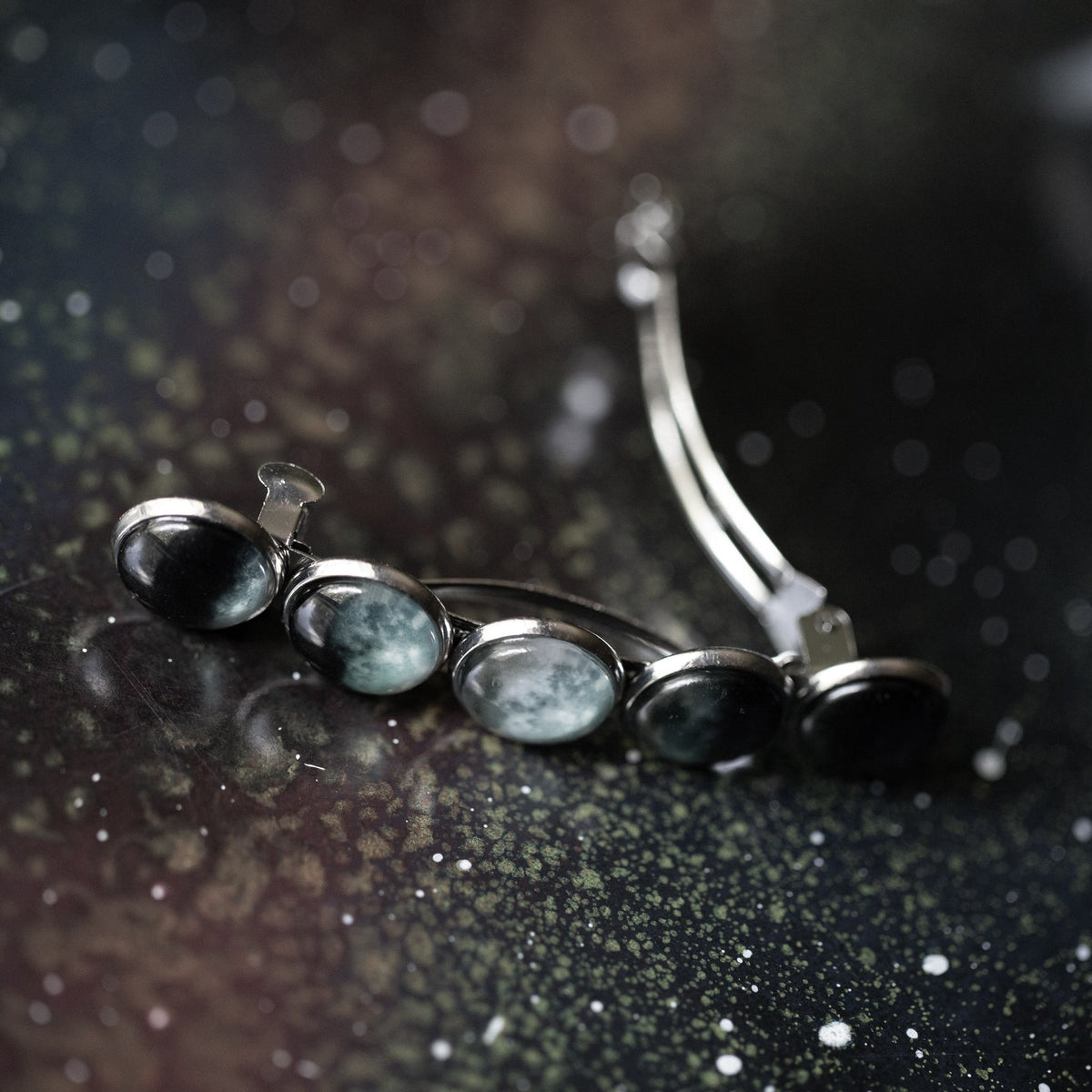 Silver hair clip barrette with oval black and teal cabochons