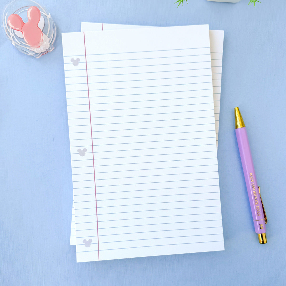 Lined paper notepad with hidden Mickey icons, red margin guide lines, and blank pages