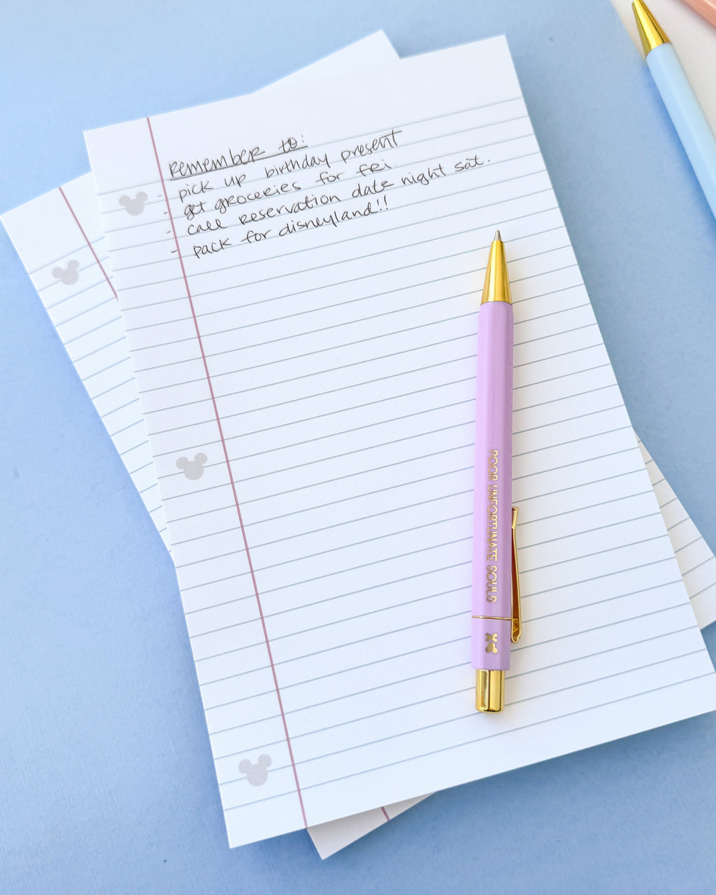 Lined paper notepad pages with red margin line and hidden Mickey icons, with pen