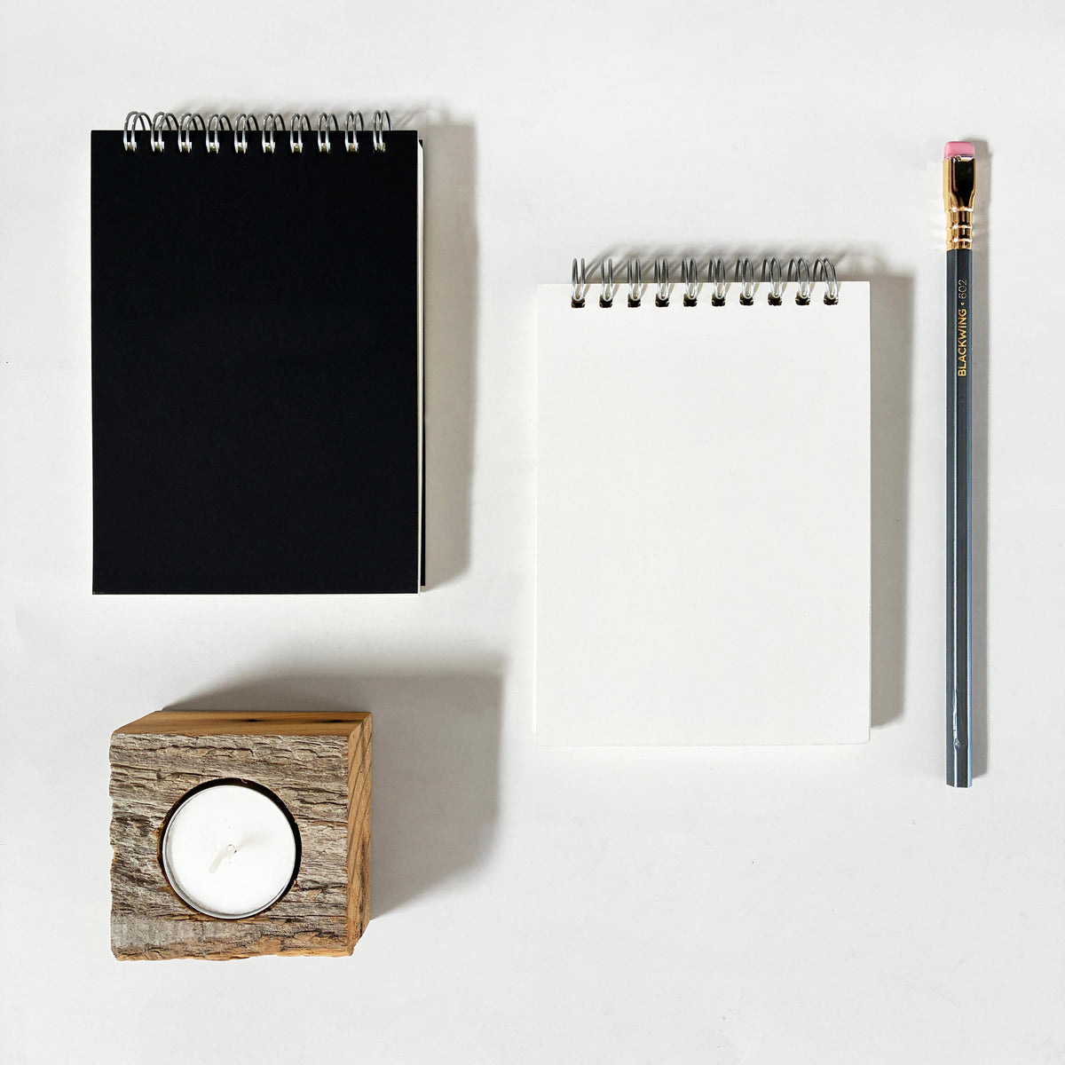 Black and white spiral notebooks with metal coil binding and blank covers