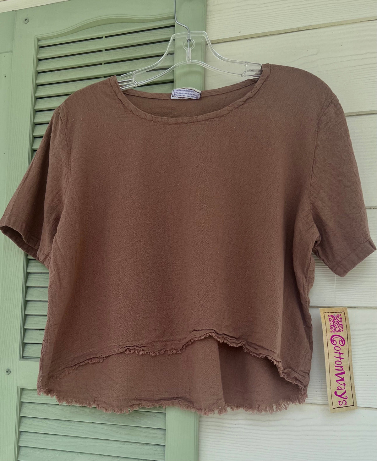 Brown cotton gauze Heidi top on hanger, crew neck short sleeves with frayed raw hem