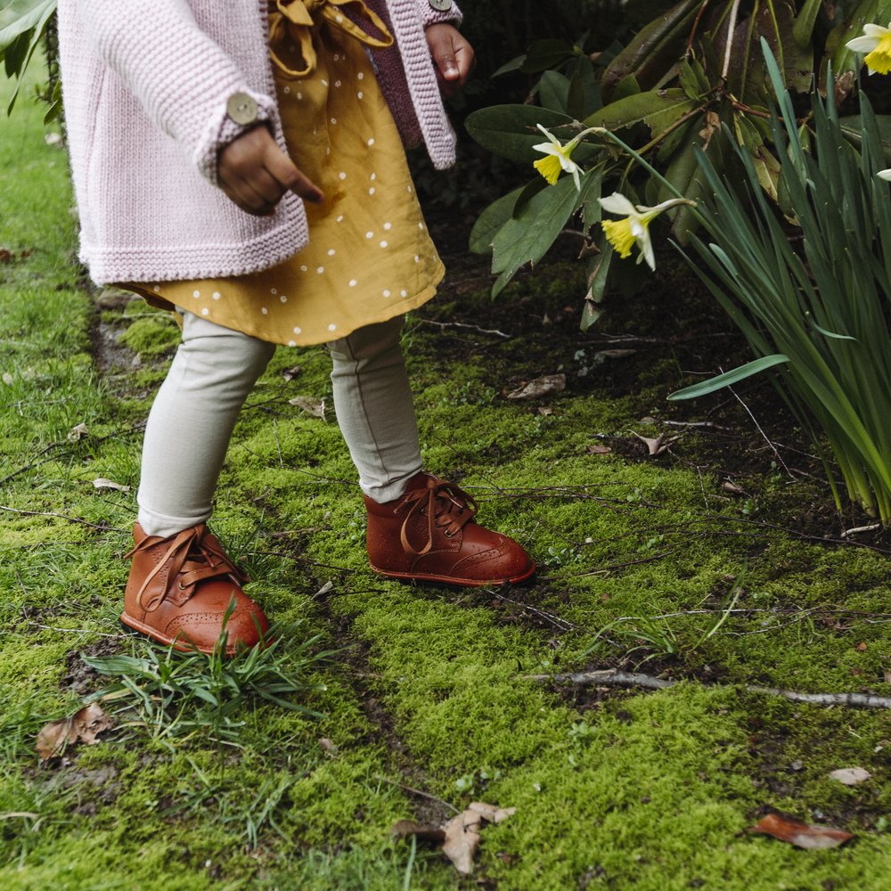 Chestnut kids lace-up boots with tied laces and stitched details on flexible sole
