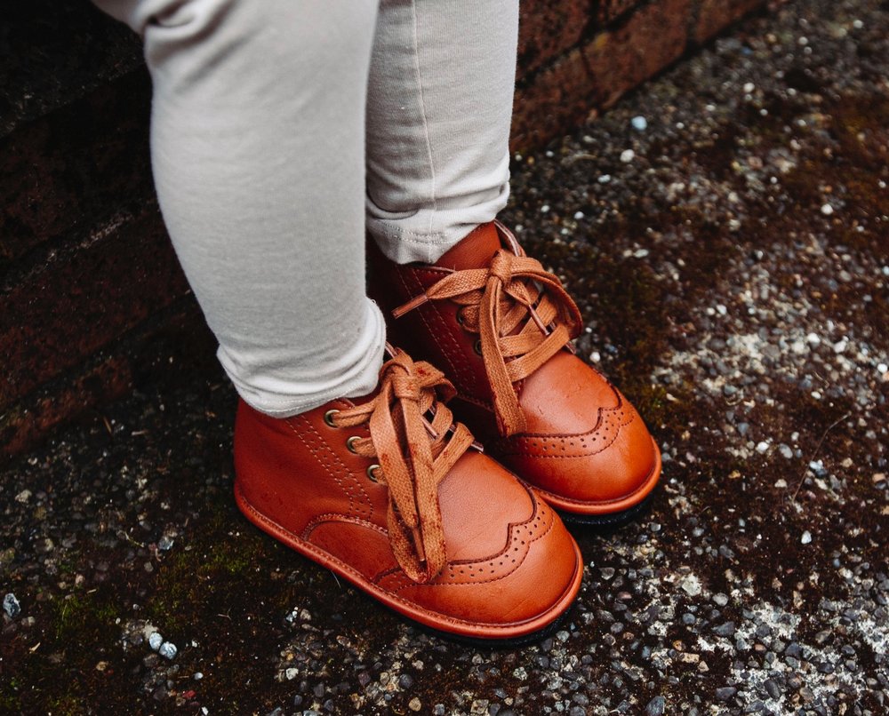 Chestnut kids lace-up boots worn, tied laces, stitched toe and panel details