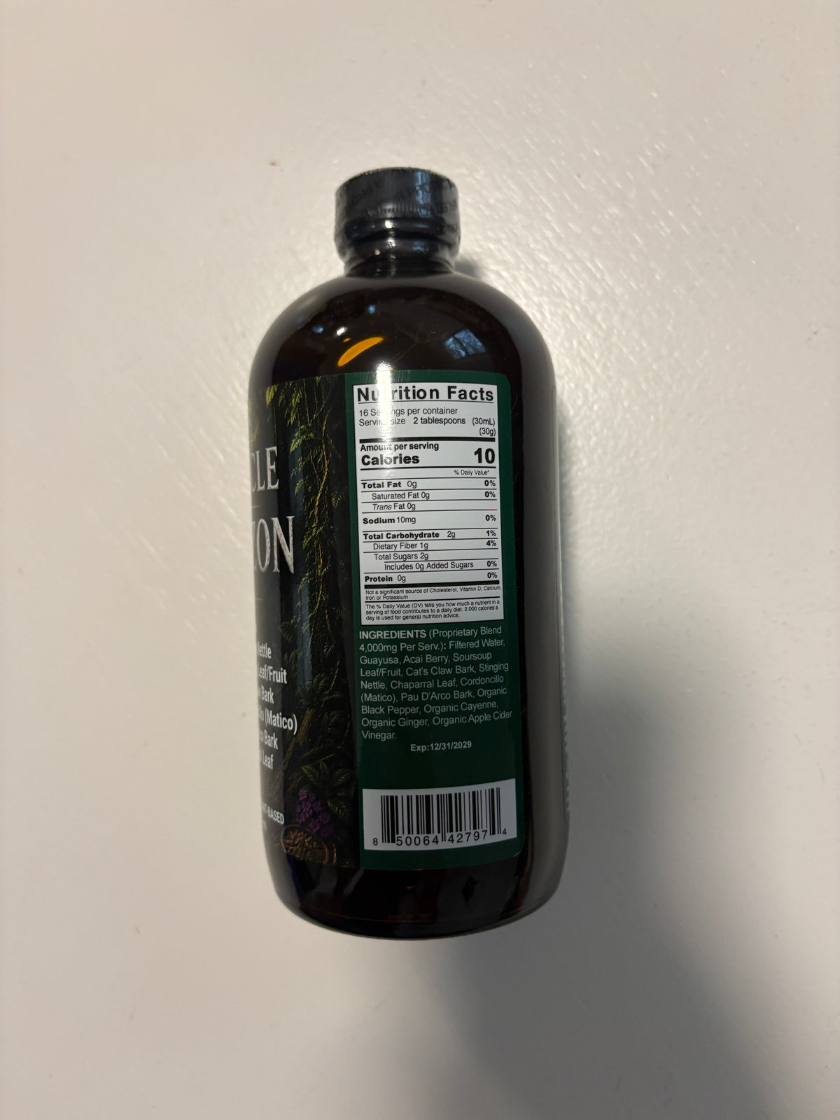 Amber herbal liquid blend bottle showing Nutrition Facts, ingredients, and barcode on the back