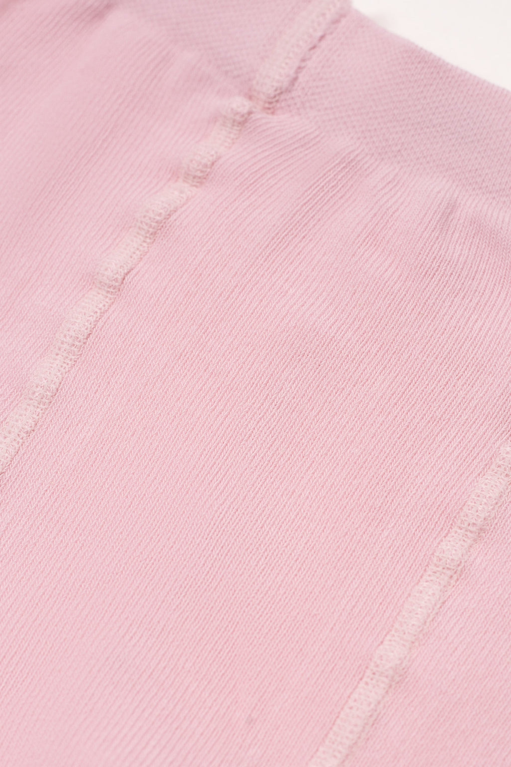 Light pink kids cotton tights with small brown heart pattern, waistband seam detail