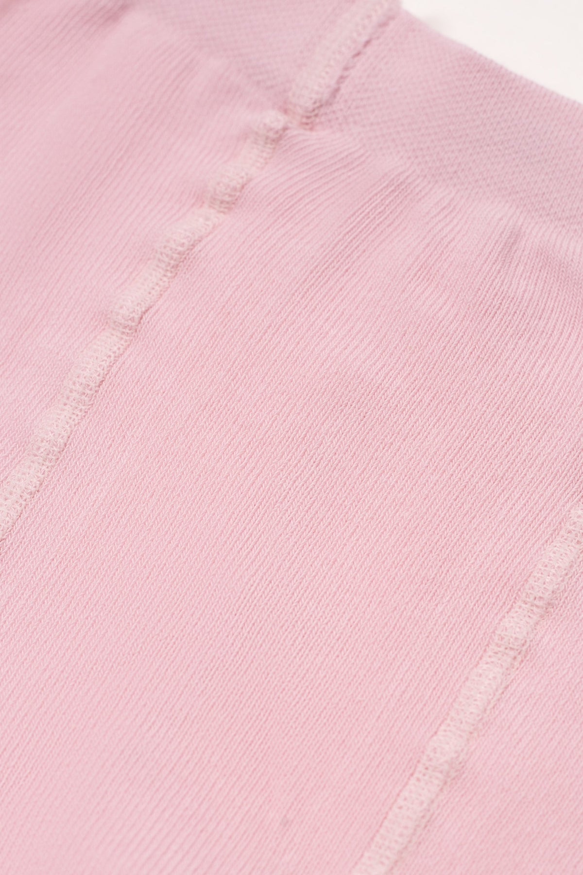 Light pink kids cotton tights with small brown heart pattern, waistband seam detail
