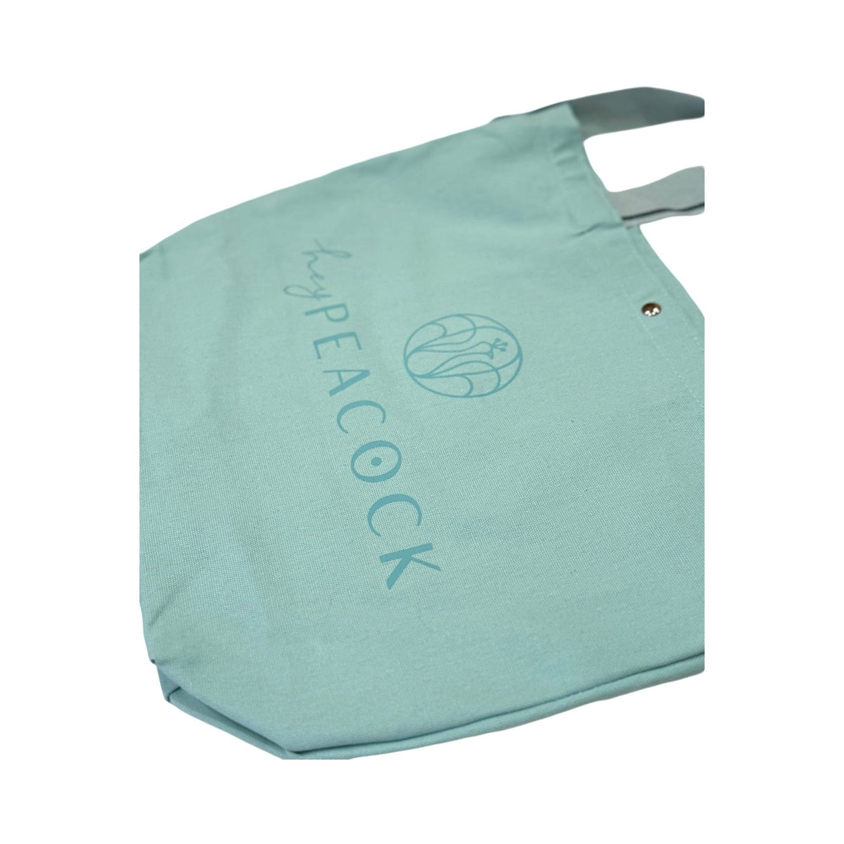 Aqua canvas tote bag with peacock logo and graphic text on back