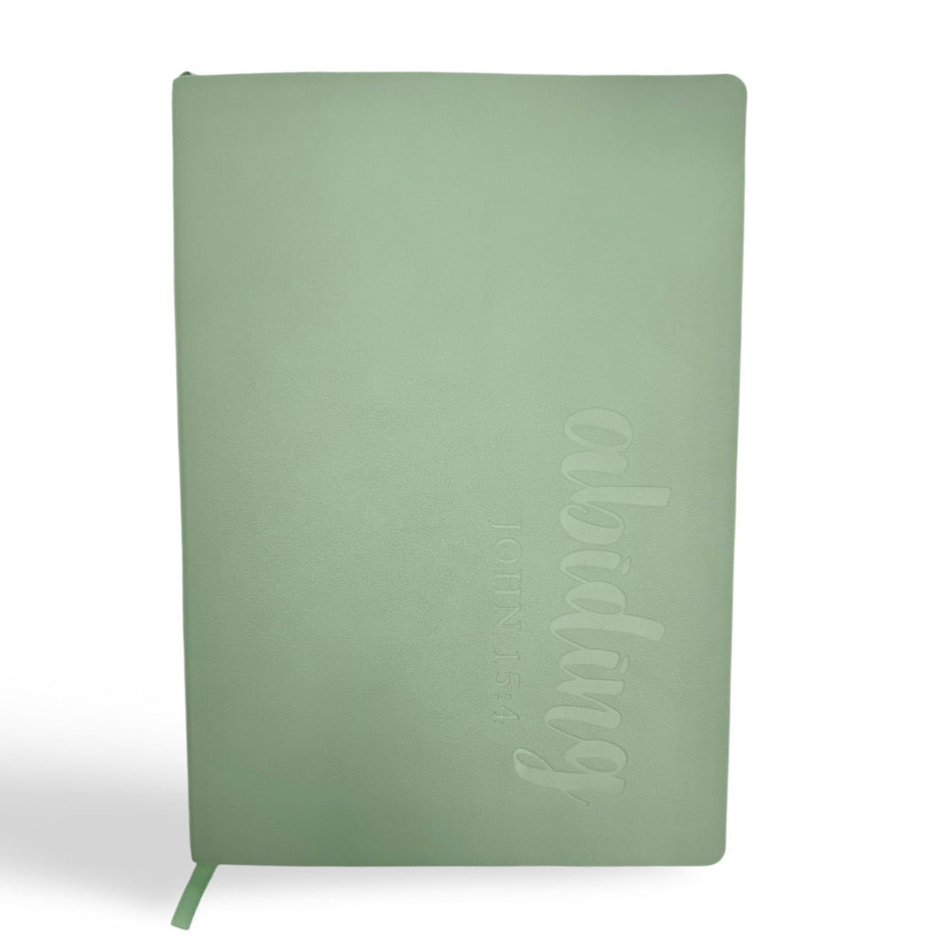 Mint green soft leather journal with embossed vertical lettering and green bookmark tab