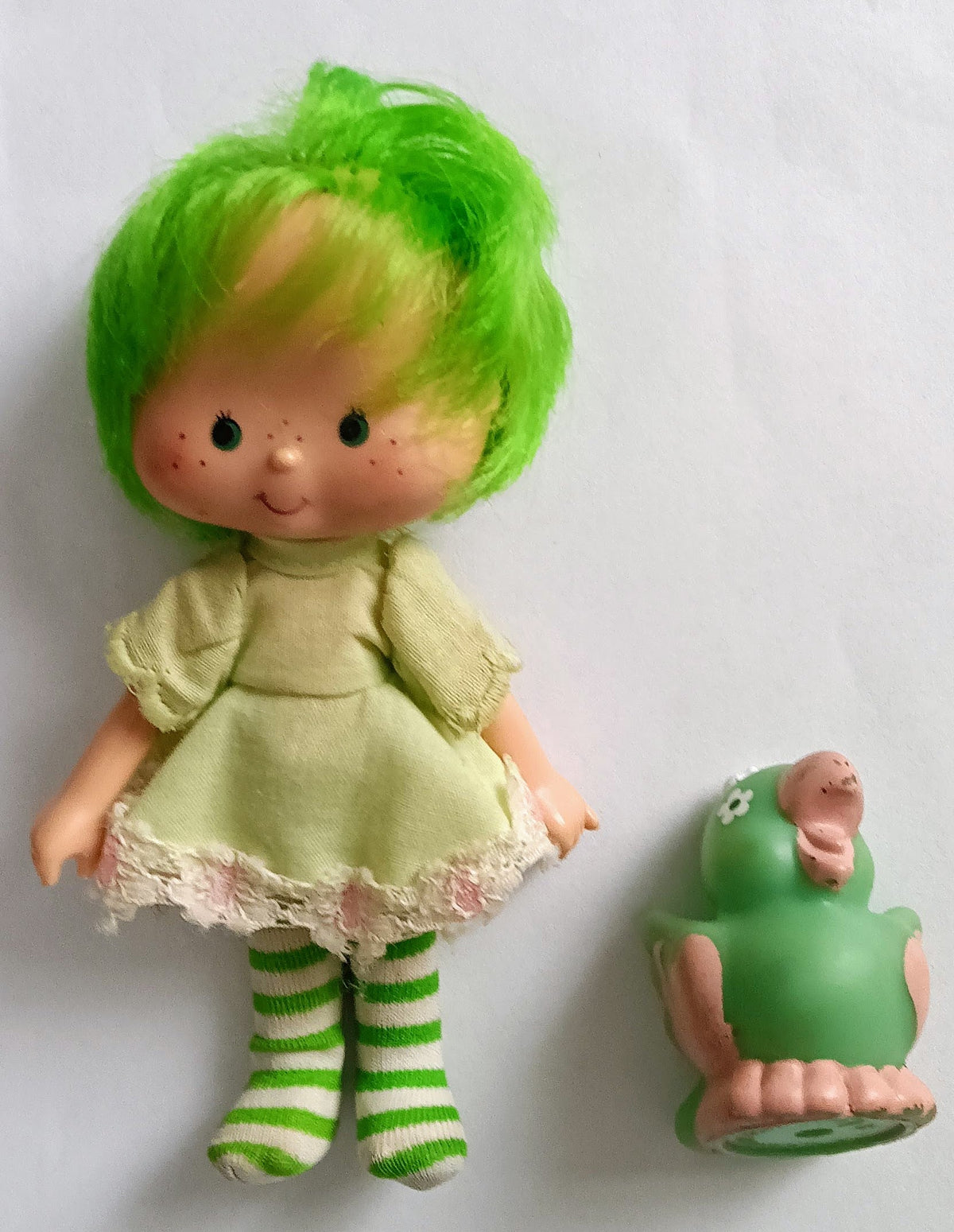 Lime chiffon doll with green bob hair, ruffled dress, striped leggings, side figure