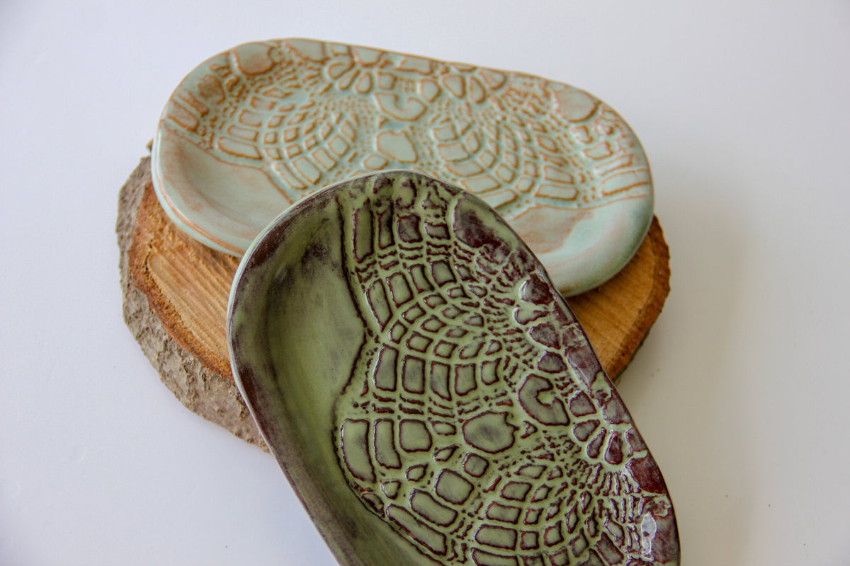 Ceramic soap dish with textured leaf relief, pale green top and dark olive interior glaze