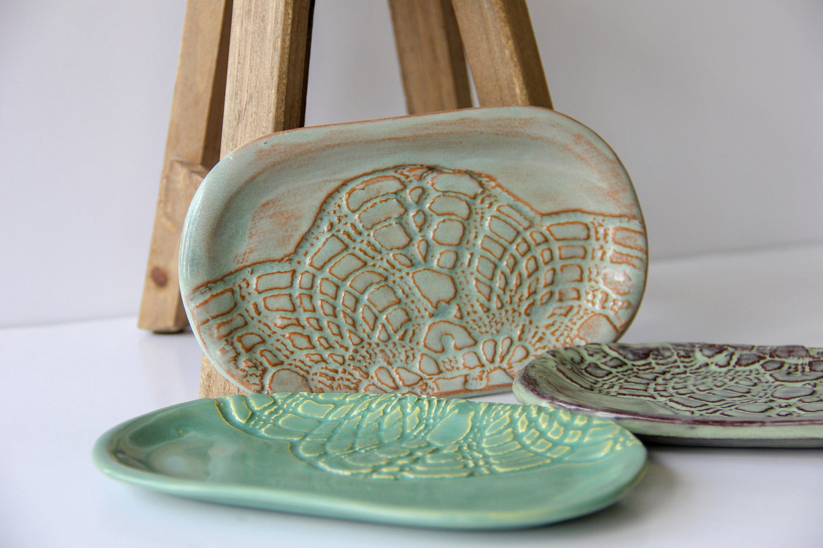 Ceramic soap dish with textured leaf design, pale teal glaze with orange-brown speckled accents