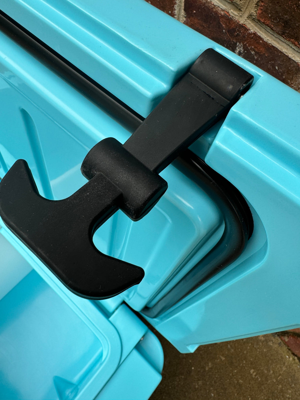 Caribbean blue cooler lid latch with black handle and mounting hinge