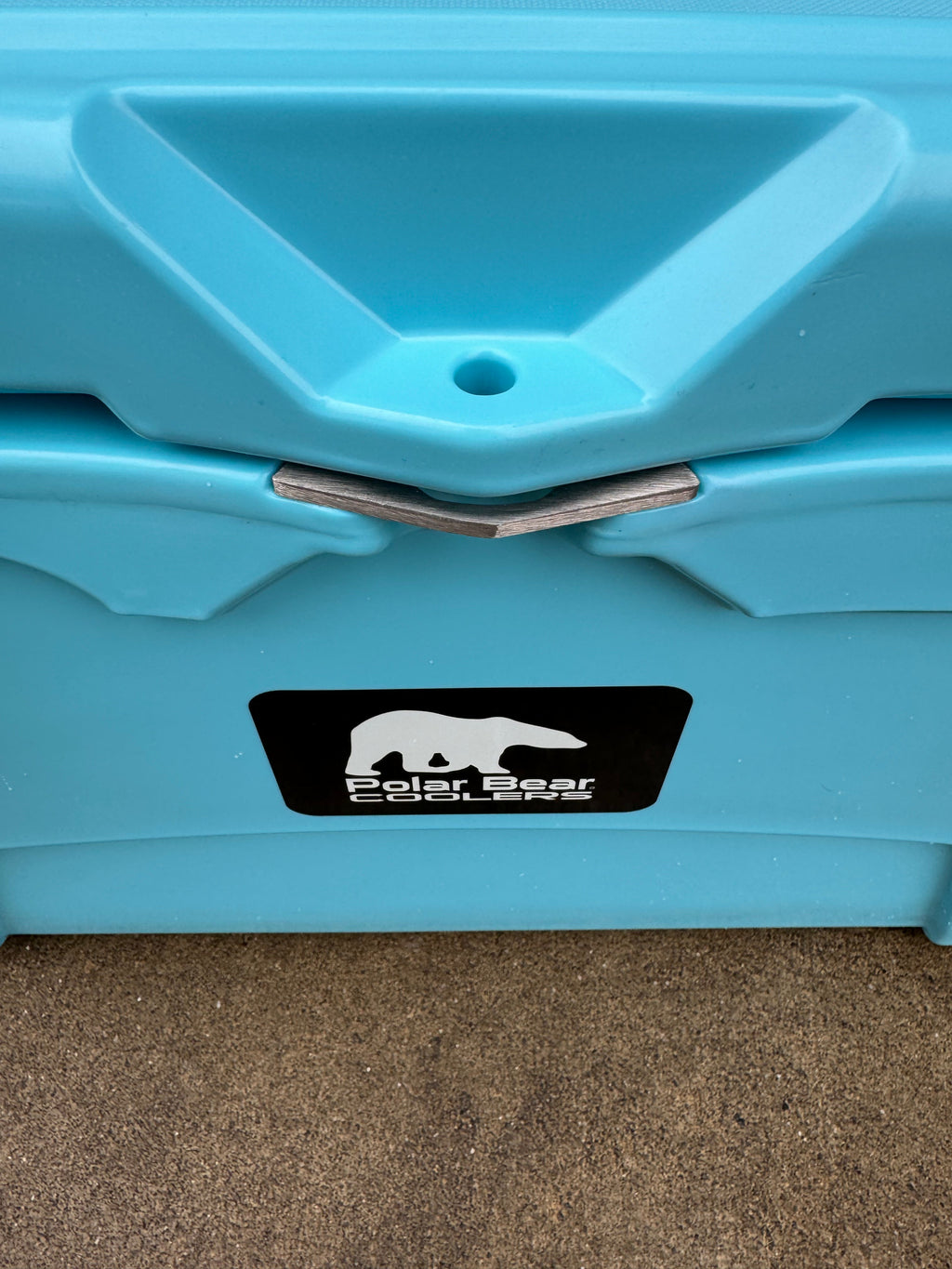Caribbean blue cooler front drain area with Polar Bear Coolers logo label