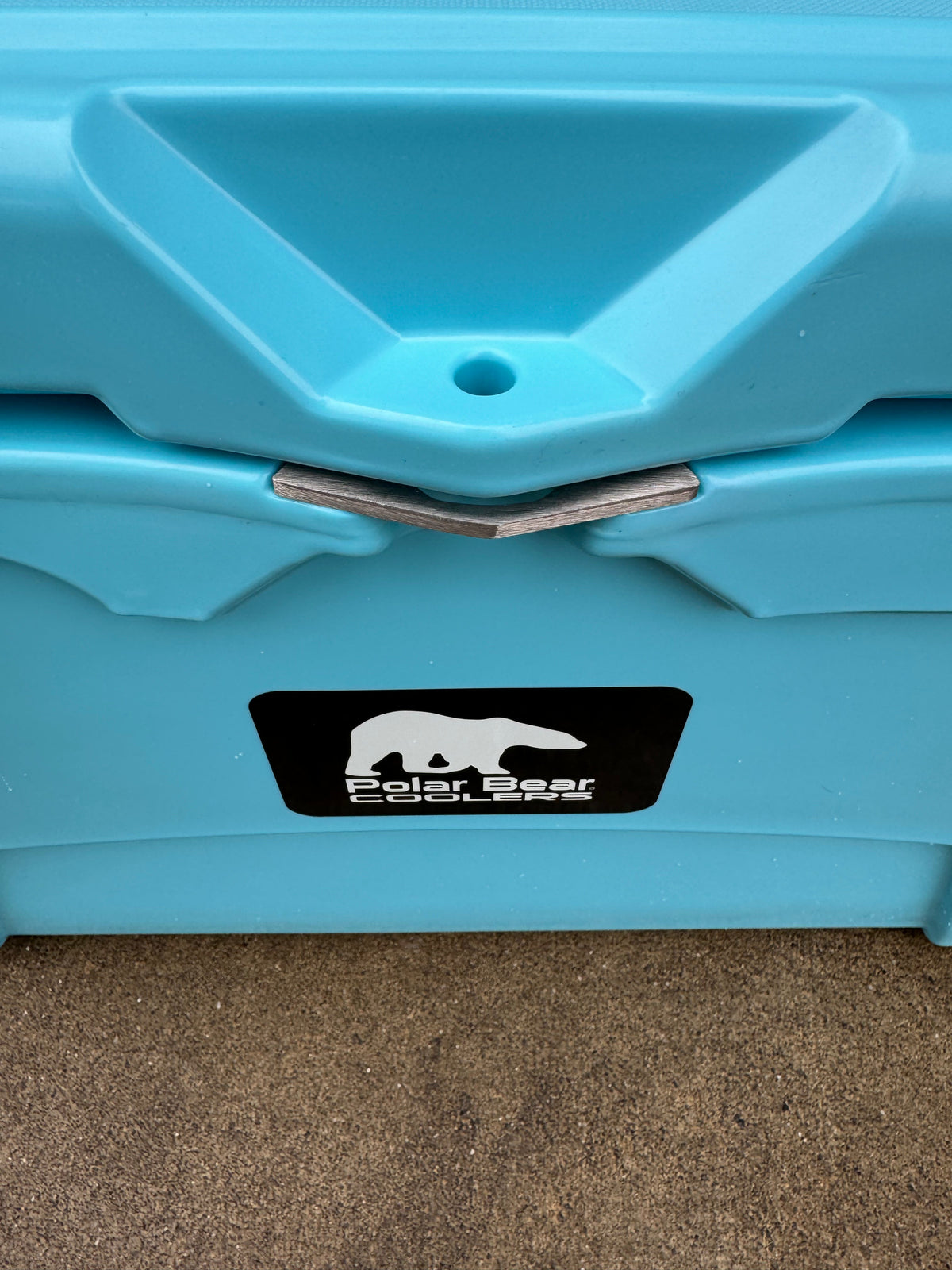 Caribbean blue cooler front drain area with Polar Bear Coolers logo label