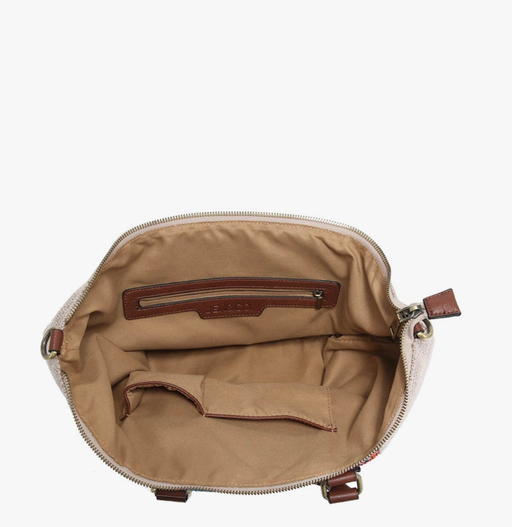 Open satchel interior with tan lining and zippered pocket