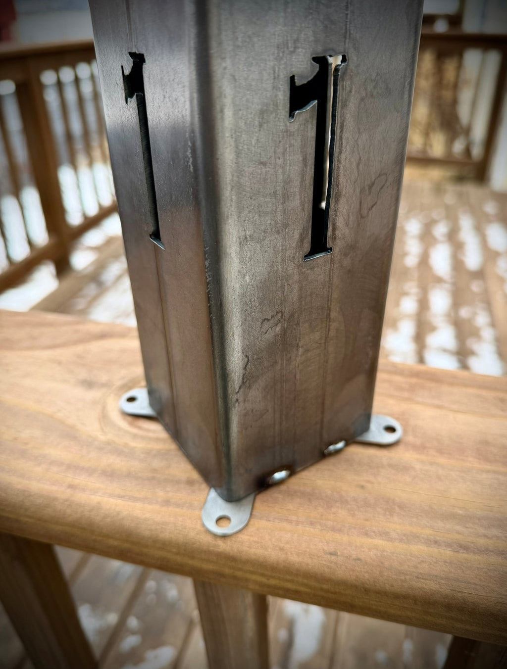 Steel solar address pillar light with large number cutouts 4 and 1 on the post