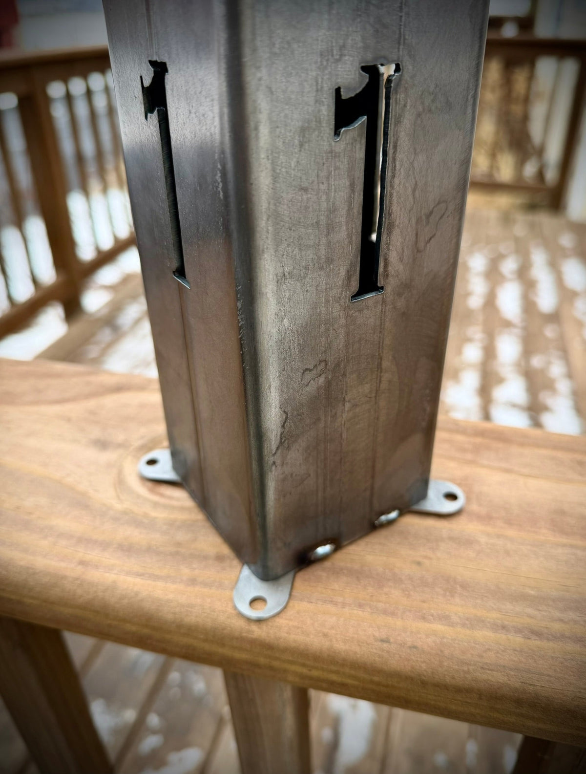 Steel solar address pillar light with large number cutouts 4 and 1 on the post