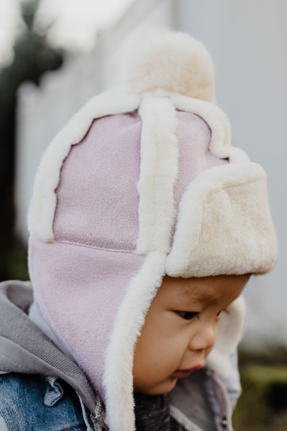 Kids sherpa aviator hat with ear flaps, lavender and cream fleece, worn by child