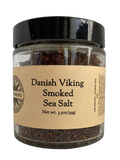 Smoked sea salt in clear glass jar with black lid, beige label and net weight