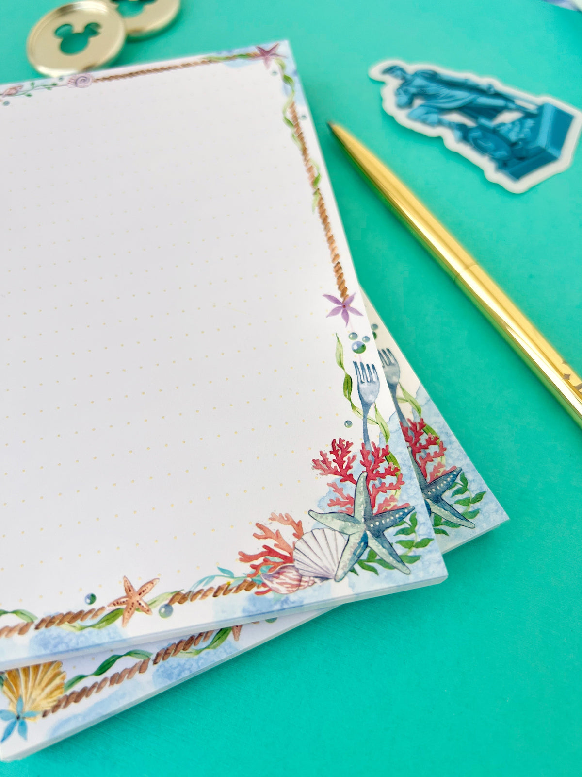 Sea-themed memo notepad page with coral-and-starfish border along edge