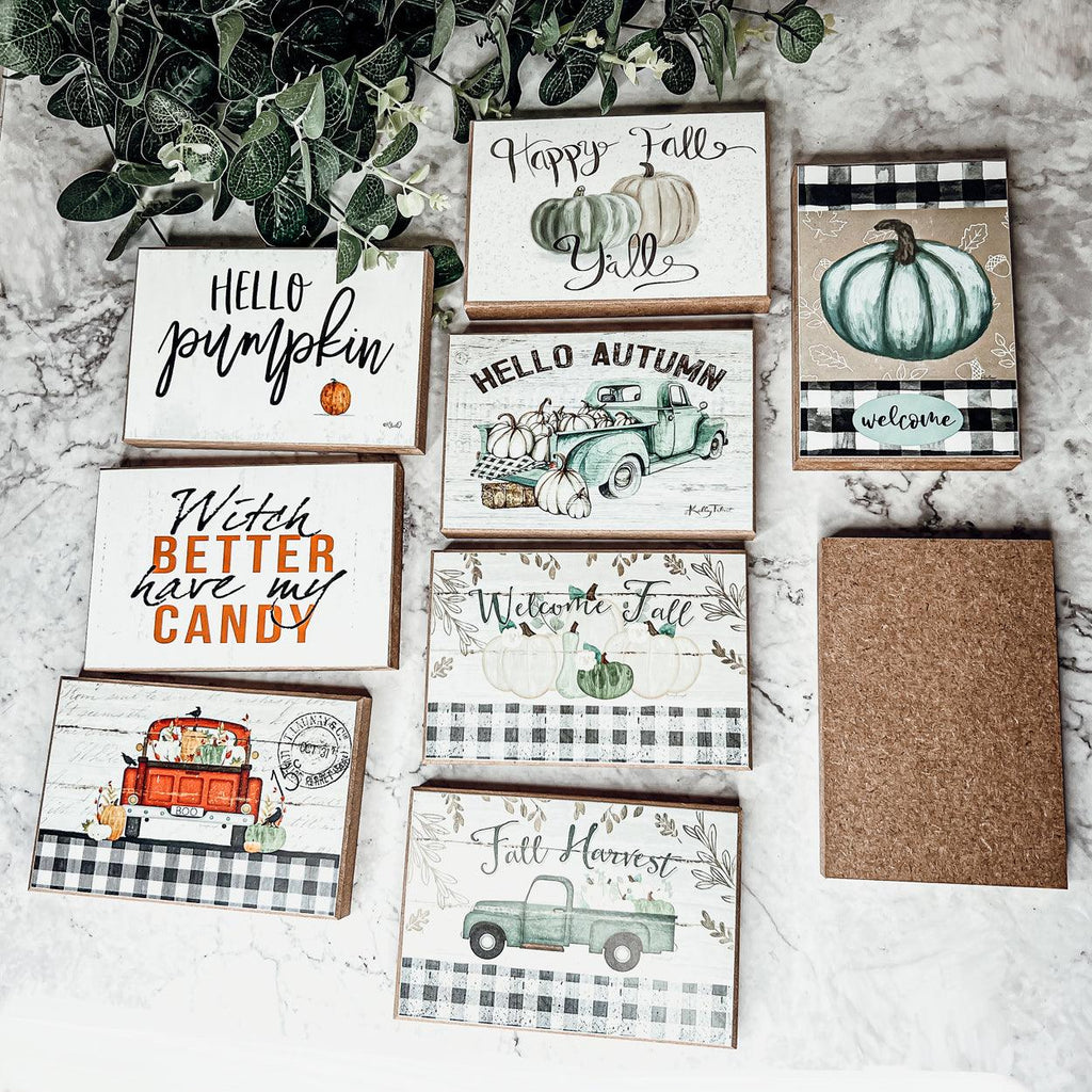 Assorted fall greeting cards on marble, including witch theme and welcome designs