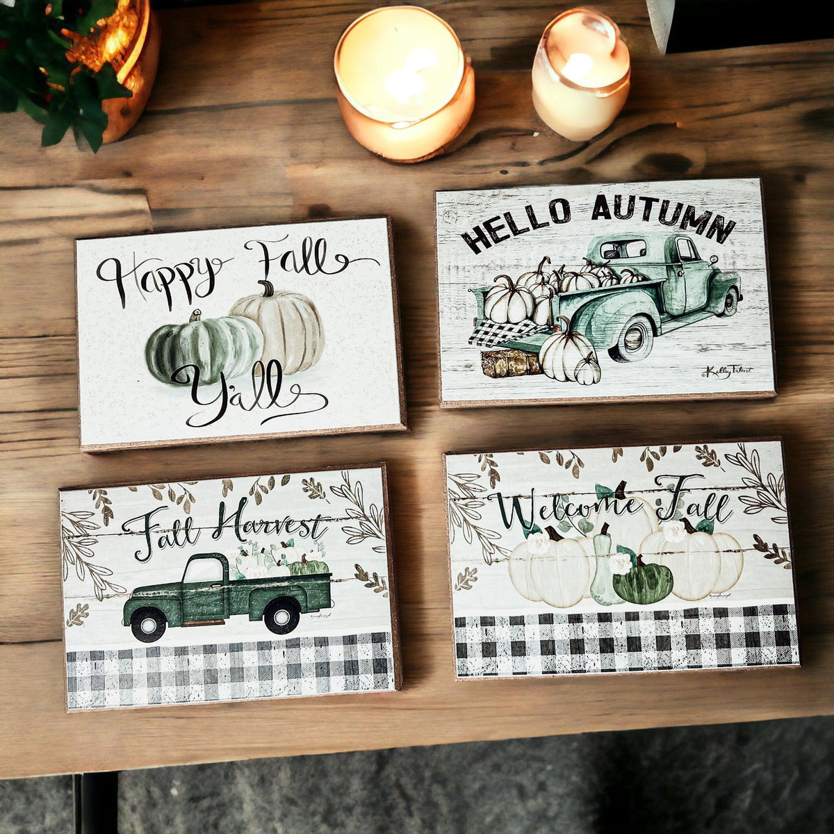 Four fall greeting cards on wood with candles above and green truck artwork