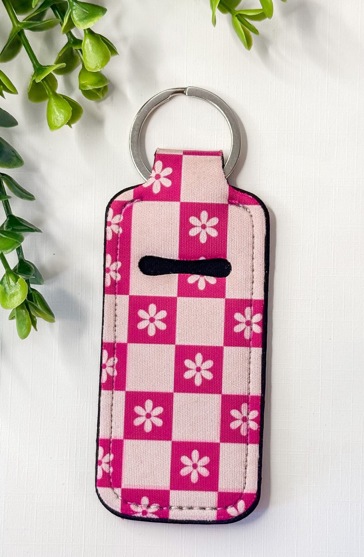 Chapstick holder keychain with pink checkered floral grid pattern and metal ring