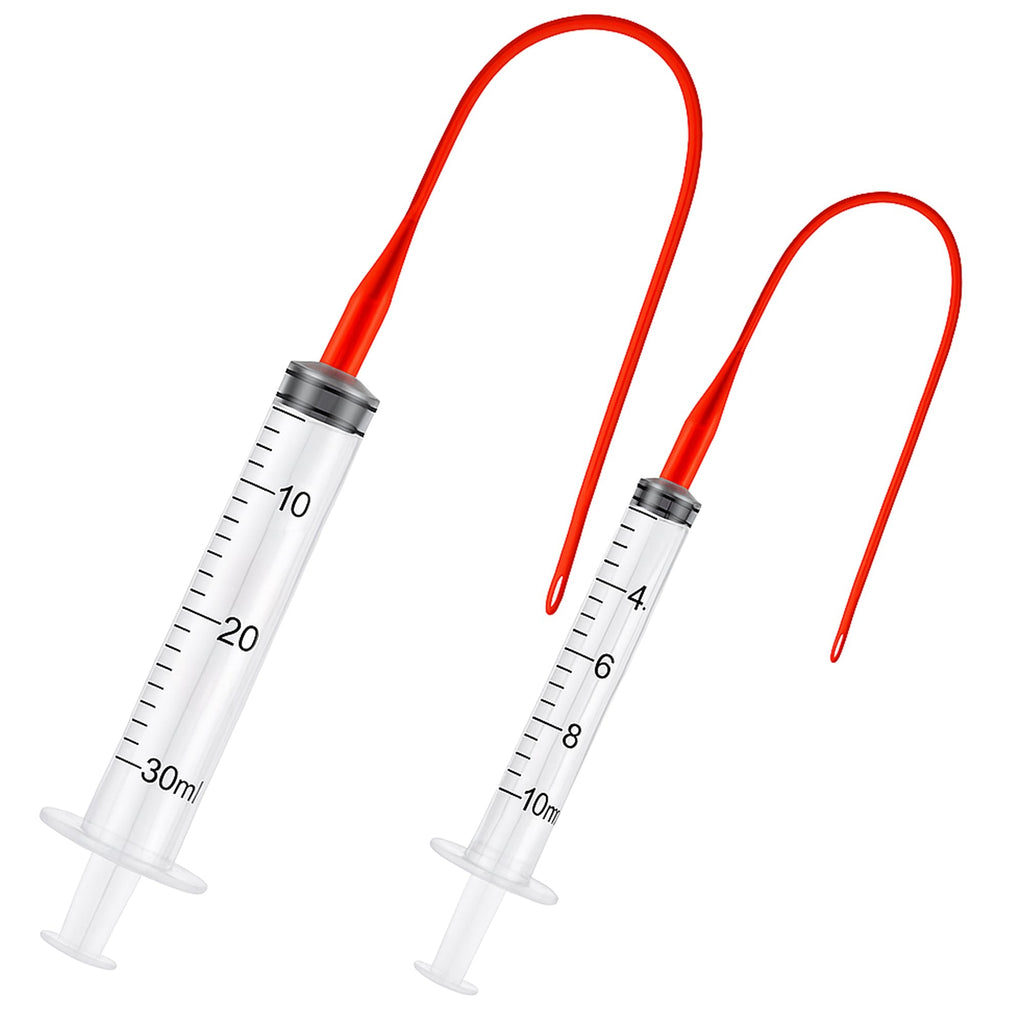 Clear oral feeding syringe set with red tube attachments and 10ml/30ml markings