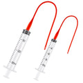 Clear oral feeding syringe set with red tube attachments and 10ml/30ml markings