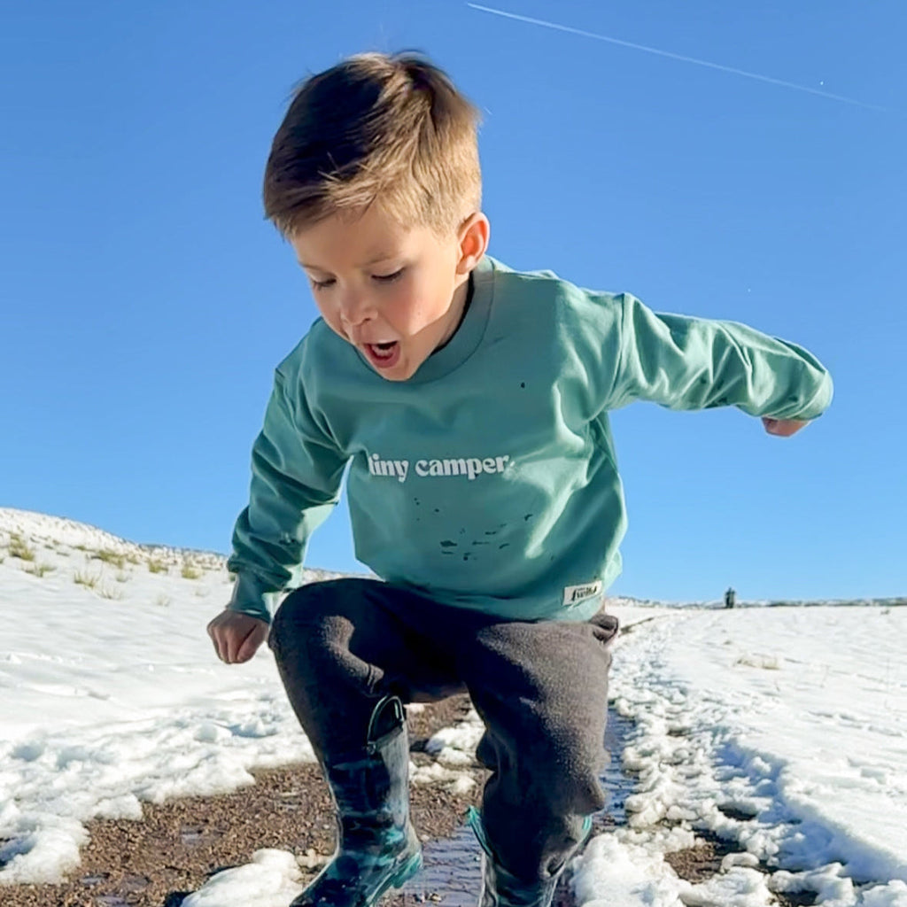 Teal crewneck pullover on a child, long sleeves and ribbed hem.
