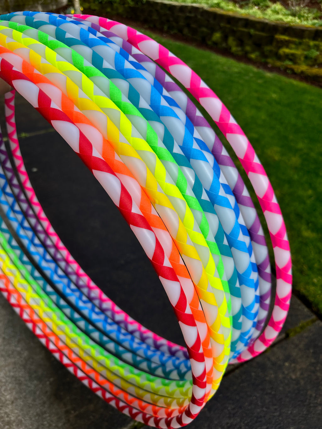 Beginner hula hoop with multicolor striped spiral gaffer tape, angled view