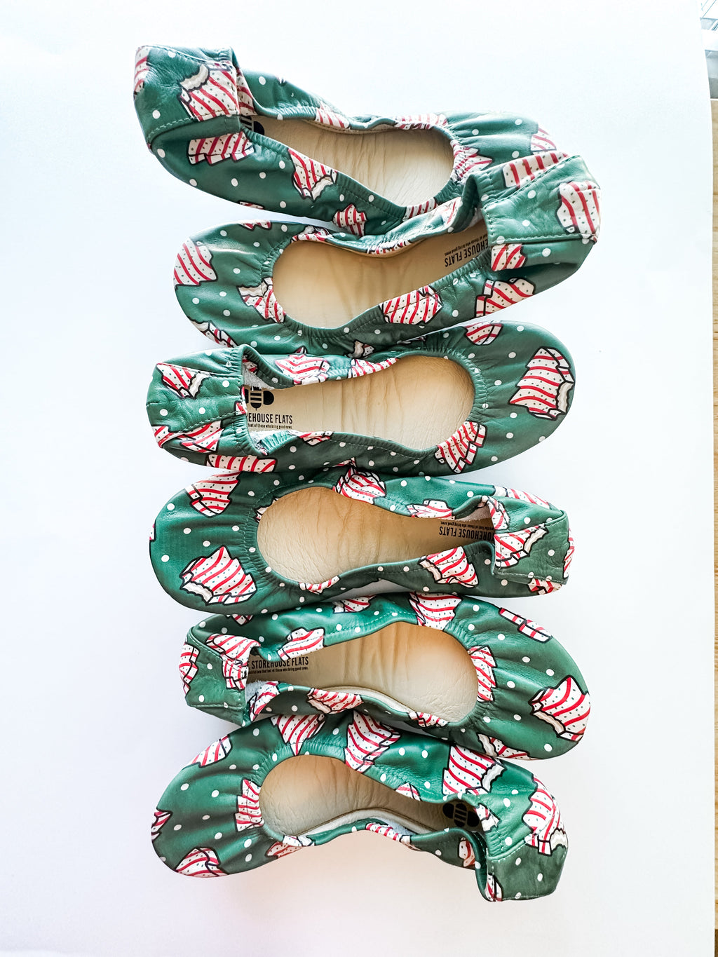Set of green candy cane patterned slip-on shoes with open toe, layered view